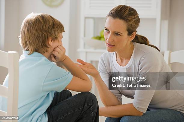 mother having discussion with son - punizione foto e immagini stock