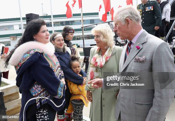 Camilla, Duchess of Cornwall and Prince Charles, Prince of Wales meet traditional throat singers during an official welcome ceremony at Nunavut...