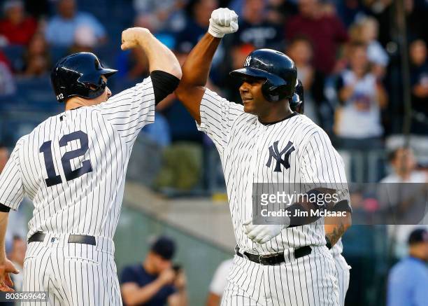 Chris Carter and Chase Headley of the New York Yankees in action against the Boston Red Sox at Yankee Stadium on June 7, 2017 in the Bronx borough of...