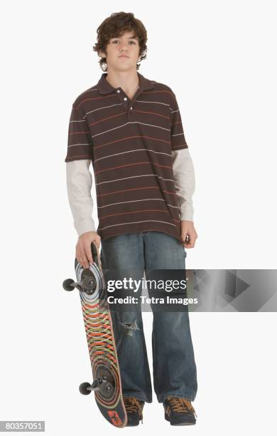 teenaged boy holding skateboard - skater isolated stock pictures, royalty-free photos & images