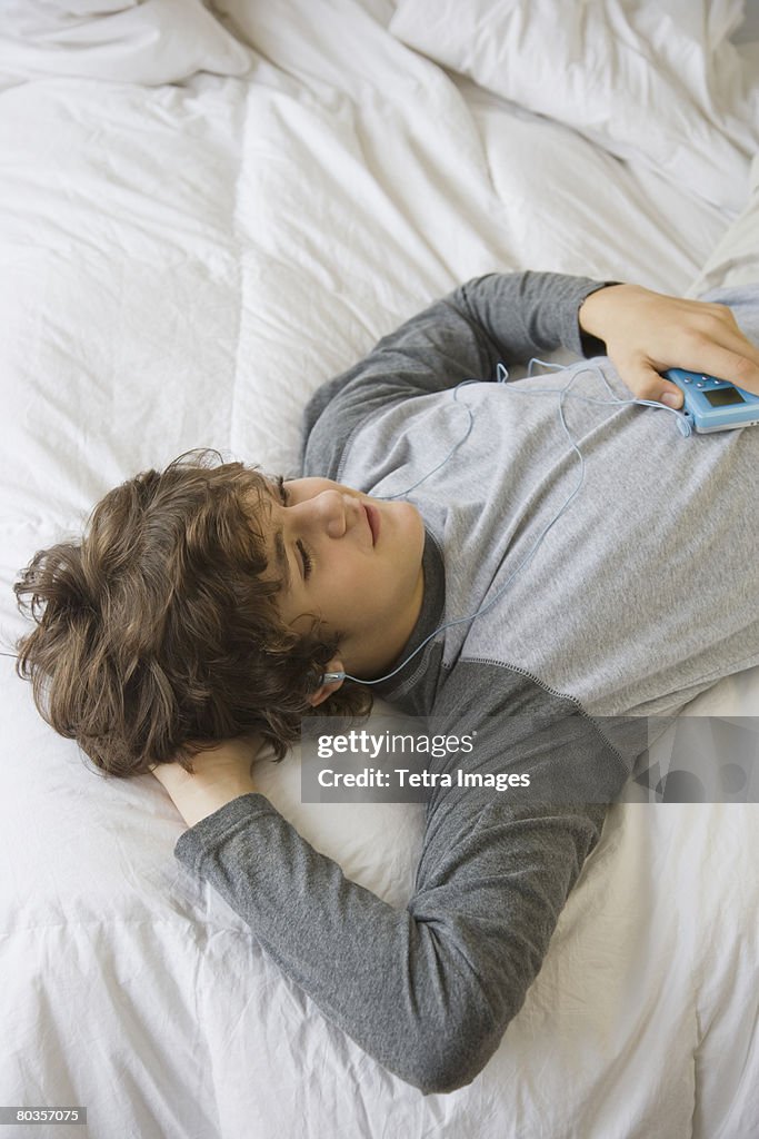 Teenaged boy listening to mp3 player