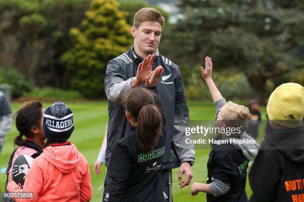 Jordie Barrett high-fives children during a New Zealand All Blacks skills and drills session on the North Lawn of Government House on June 30, 2017...