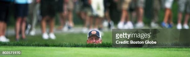 After blasting out of a gren side sand trap on the 2nd hole, Mark Calcavecchia peers above the grass line to see where his ball went during the first...