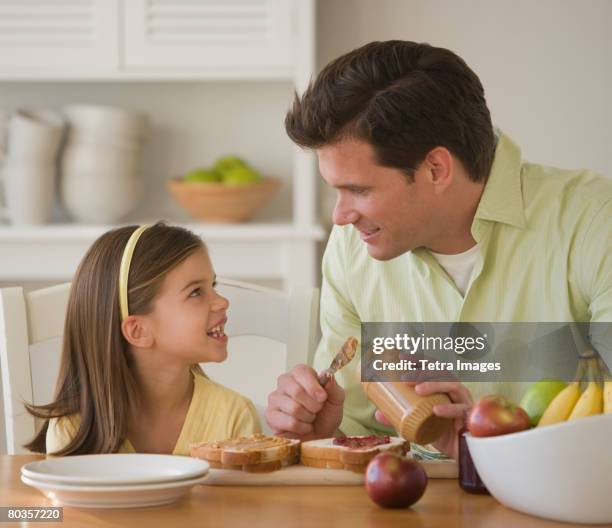 father and daughter making sandwich - peanut butter and jelly sandwich on plate stock pictures, royalty-free photos & images