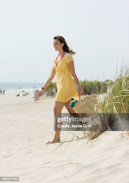 woman walking on beach - beach bag stock pictures, royalty-free photos & images