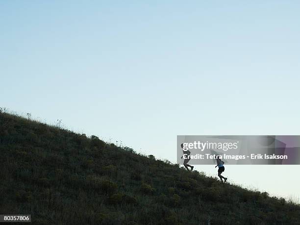 people running up mountain, salt flats, utah, united states - uphill stock pictures, royalty-free photos & images