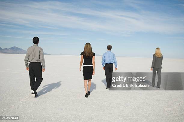 businesspeople walking on salt flats, salt flats, utah, united states - four people walking away stock pictures, royalty-free photos & images