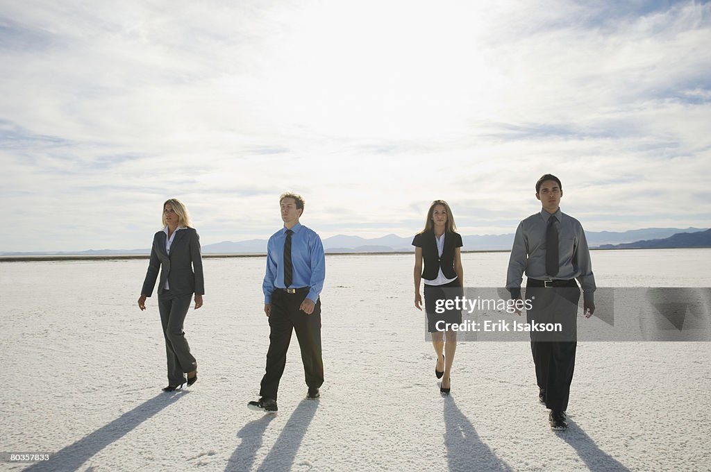 Businesspeople walking on salt flats, Salt Flats, Utah, United States