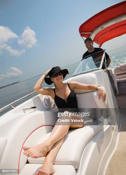 couple relaxing on boat, florida, united states - driving barefoot stock pictures, royalty-free photos & images