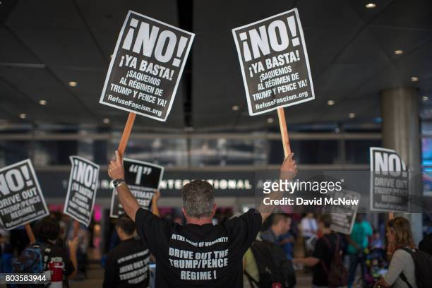 Activists protest on the first day of the the partial reinstatement of the Trump travel ban, temporarily barring travelers from six Muslim-majority...
