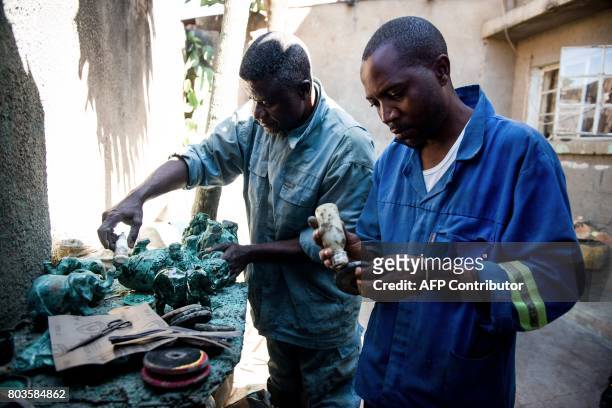 This photograph taken on May 11 shows malachite workers handling malachite stones at a malachite wokshop in Lubumbashi, DR Congo. There is no...