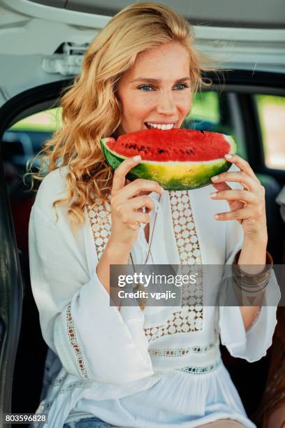 woman eating watermelon on the road trip - woman melons stock pictures, royalty-free photos & images