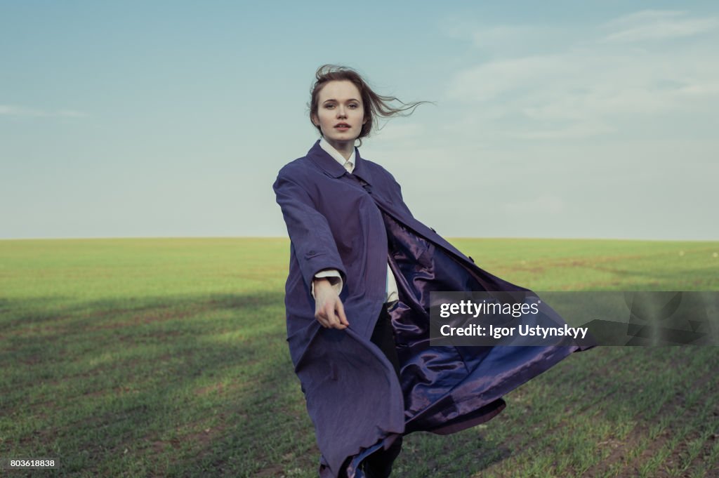Portrait of woman in the field in coat
