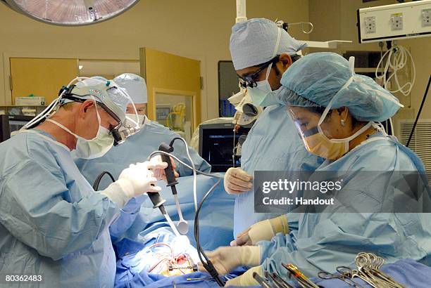 In this handout photo provided by Childrens Hospital Los Angeles, heart surgeon Dr. Vaughn Starnes and his surgical team restart the heart of...