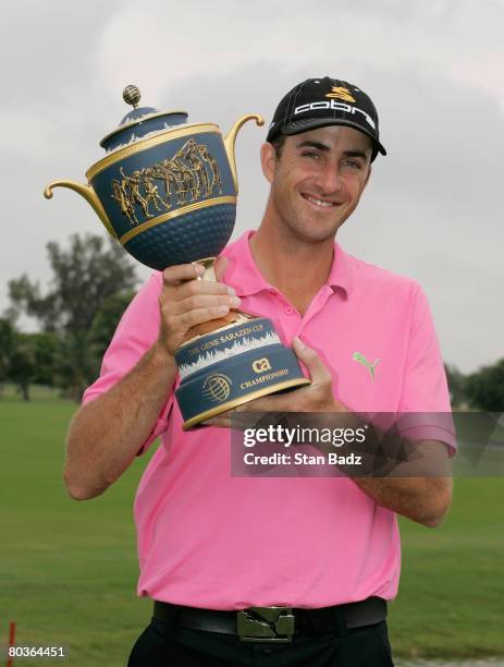 Geoff Ogilvy holds the the winner's trophy after the completion of the final round of the WGC-CA Championship held on March 24, 2008 on the Blue...