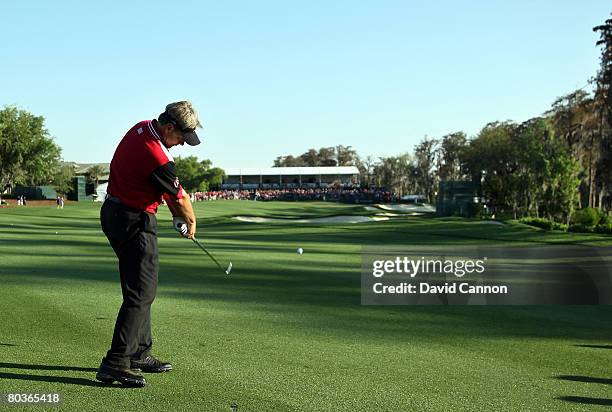 John Cook, of the Isleworth team, plays his second shot to the 18th hole during the first day's play of the Tavistock Cup at Isleworth Golf and...