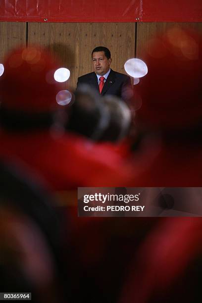 Venezuelan President Hugo Chavez listens to Oil Minister Rafael Ramirez's speech in the Simon Bolivar hall during a meeting with Petroleos de...