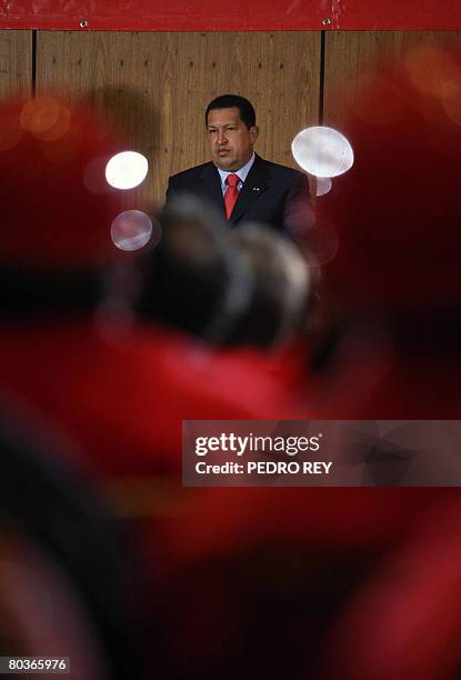 Venezuelan president Hugo Chavez listens to Energy minister and PDVSA president Rafael Ramirez's speech at the Simon Bolivar hall during a meeting...
