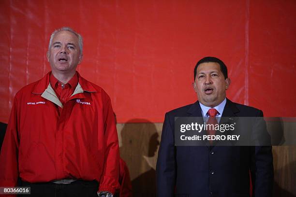 Venezuelan Oil Minister Rafael Ramirez and President Hugo Chavez sing the national anthem during a meeting to celebrate the court decision against US...