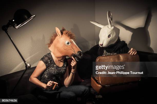 film noir style scene - rabbit and horse looking into a suitcase after crime - art dealer stock-fotos und bilder