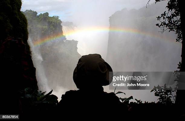 Canadian tourist takes in the scene as the Zambezi River plunges 420 feet March 17, 2008 at Victoria Falls, Zimbabwe. Considered one of the world's...