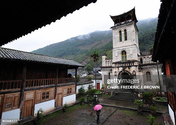 By Robert J. Saiget A man goes to church on Good Friday at the Tibetan Catholic Church in Cizhong on March 21, 2008 in the remote mountains of...
