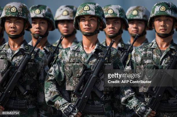 People's Liberation Army soldiers prepare for the arrival of China's President Xi Jinping at a barracks in Hong Kong on June 30, 2017. Xi arrived in...