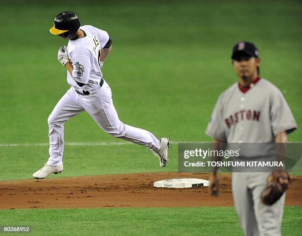 Oakland Athletics second baseman Mark Ellis hits a home run as Boston Red Sox Japanese pitcher Daisuke Matsuzaka stans during the first inning of...