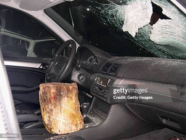 Police handout photo shows a 6kg block of wood and the car it struck killing a woman sitting on the passenger seat in the evening of March 23 near...