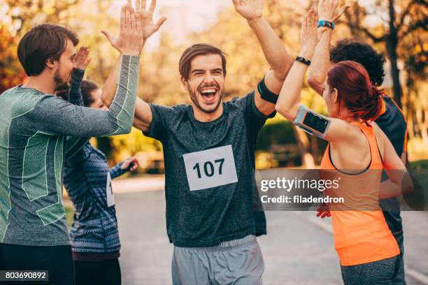 man at the finish line - hi 5 stock pictures, royalty-free photos & images