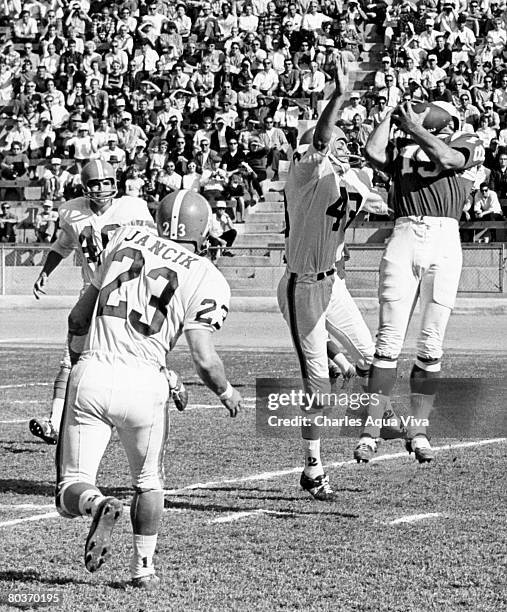 San Diego Chargers wide receiver Lance Alworth makes a catch in front of Houston Oilers safety Jim Norton , Tony Banfield , and Bobby Jancik during a...