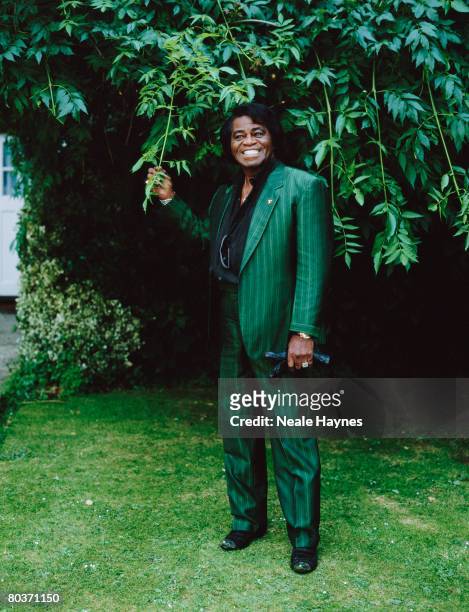 American soul singer James Brown wearing a green striped suit in a garden, 4th October 2004.