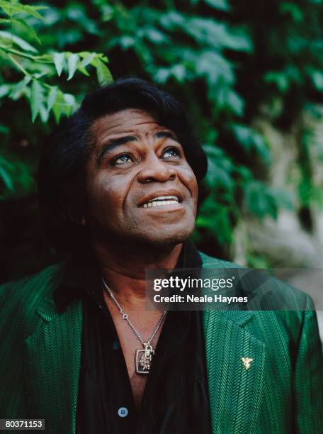 American soul singer James Brown wearing a green striped suit in a garden, 4th October 2004.