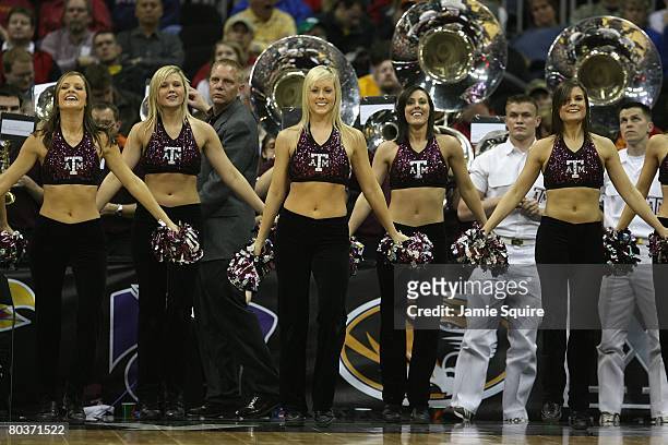 Texas A&M Aggies cheerleaders perform during the game against the Iowa State Cyclones during day 1 of the Big 12 Men's Basketball Tournament on March...