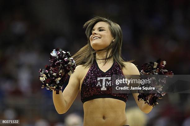 Texas A&M Aggies cheerleader performs during the game against the Iowa State Cyclones during day 1 of the Big 12 Men's Basketball Tournament on March...