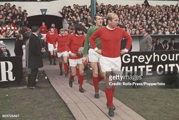 English professional footballer Bobby Charlton leads out team mates, including goalkeeper Alex Stepney and George Best behind, on to the pitch at...
