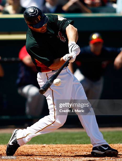 Outfielder Xavier Nady of the Pittsburgh Pirates gets into a pitch against the Minnesota Twins during the Grapefruit League Spring Training game on...