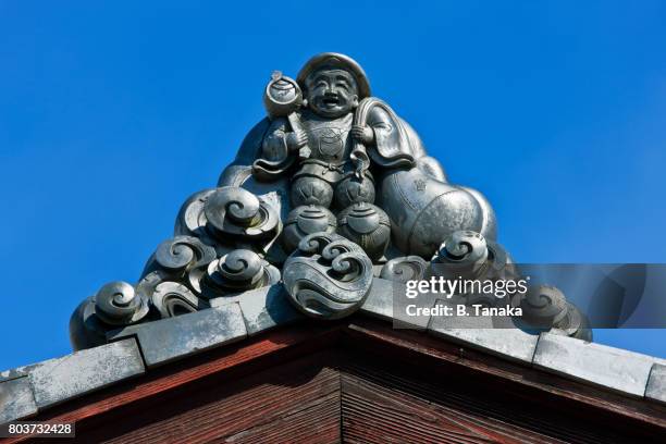 daikokuten god of fortune rooftile in kyoto, japan - shinto stock pictures, royalty-free photos & images