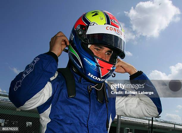 Enrique Bernoldi driver of the Conquest Racing Dallara Honda puts his helmet on during testing for the IndyCar Series at the Homestead-Miami Speedway...