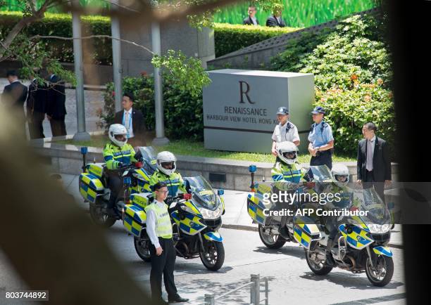 This photo taken on June 29, 2017 shows embers of Hong Kong police outside the Renaissance Hotel in the Wanchai district of Hong Kong as security has...