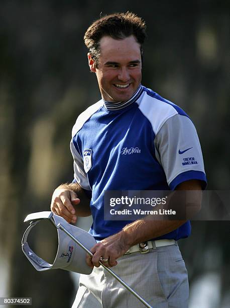 Trevor Immelman of South Africa and the Lake Nona team on the 18th green during the second day of the Tavistock Cup at Isleworth Golf and Country...