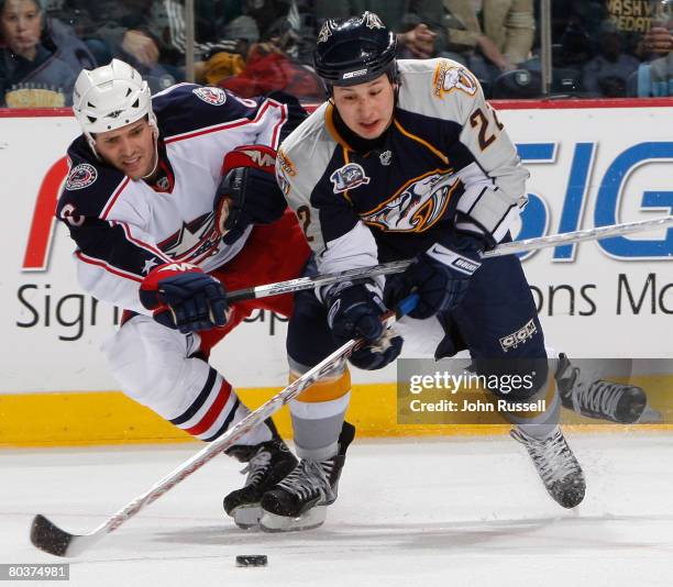 Jordin Tootoo of the Nashville Predators battles Ron Hainsey of the Columbus Blue Jackets on March 25, 2008 at the Sommet Center in Nashville,...