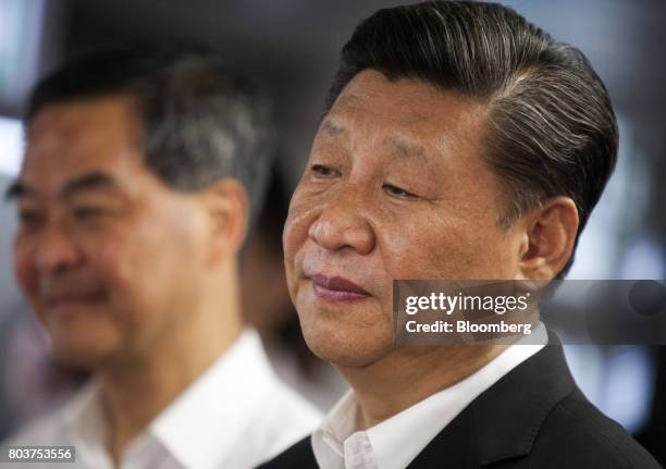 Xi Jinping, China's president, right, and Leung Chun-ying, Hong Kong's outgoing chief executive, visit the Hong Kong Police Force's Junior Police...