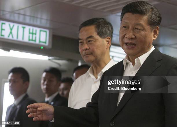 Xi Jinping, China's president, right, and Leung Chun-ying, Hong Kong's outgoing chief executive, second from right, visit the Hong Kong Police...