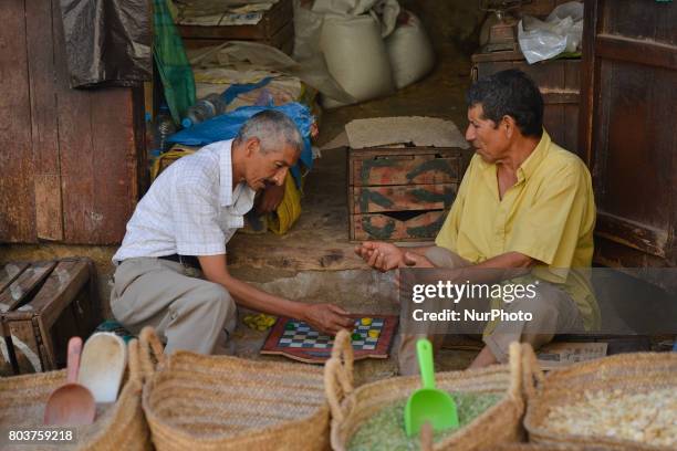 Two men playing Checkers, a scene from a daily life in Fes medina. On Thursday, June 29 in Fes, Morocco.