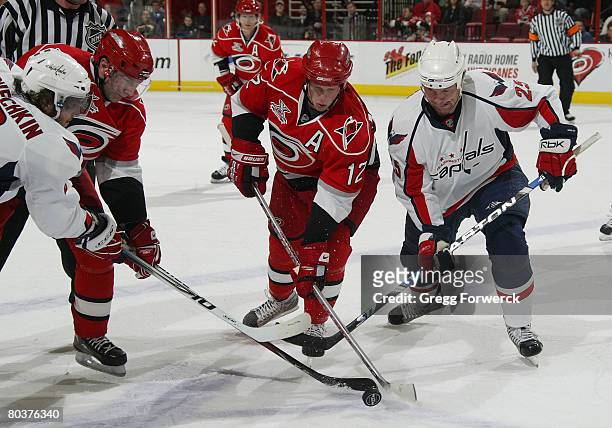 Erik Cole and Eric Staal of the Carolina Hurricanes battle for the puck with Alex Ovechkin and Vikton Kozlov of the Washington Capitals during their...