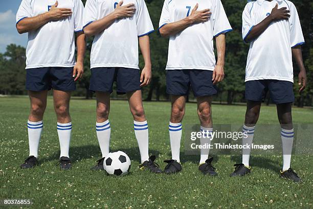 Soccer Players With Hands On Hearts, Stock-Foto