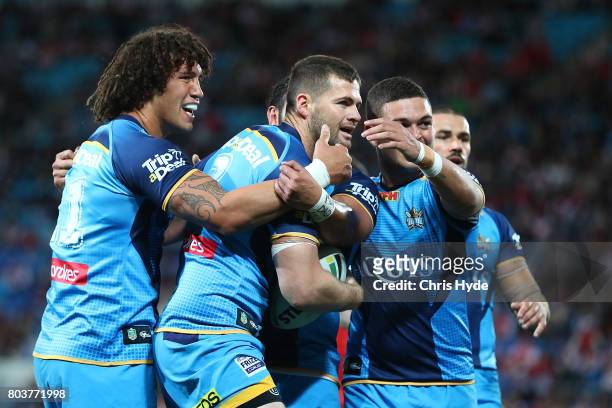 Anthony Don of the Titans celebrates after scoring a try with team mates during the round 17 NRL match between the Gold Coast Titans and the St...