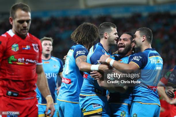 Anthony Don of the Titans celebrates after scoring a try with team mates during the round 17 NRL match between the Gold Coast Titans and the St...