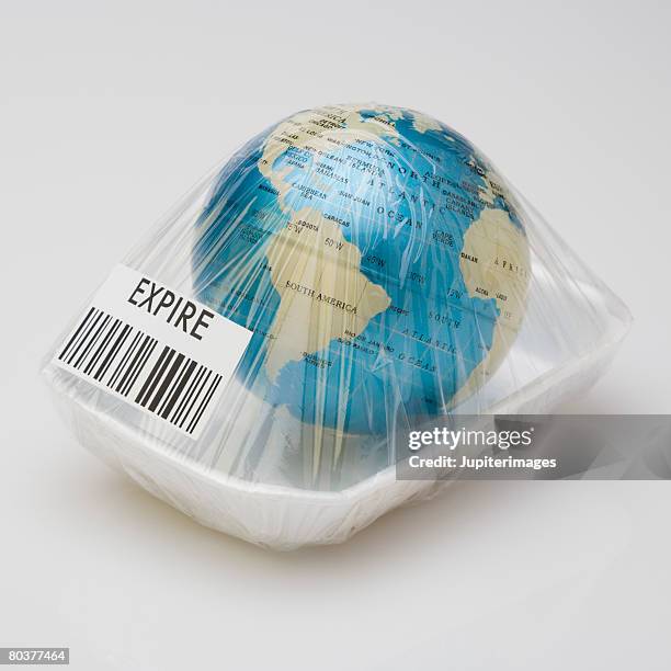 earth wrapped with cellophane - use by label stock pictures, royalty-free photos & images